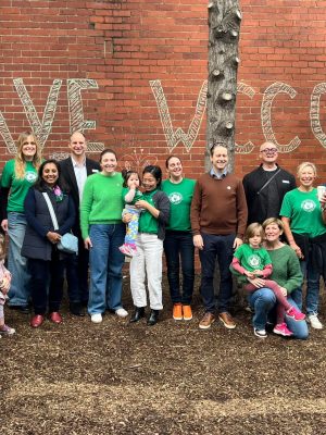 group of families from WCCC in the backyard of the centre looking cheerful